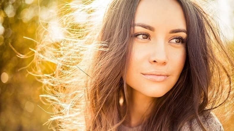 Woman outdoors with styled hair after winter skin rejuvenation