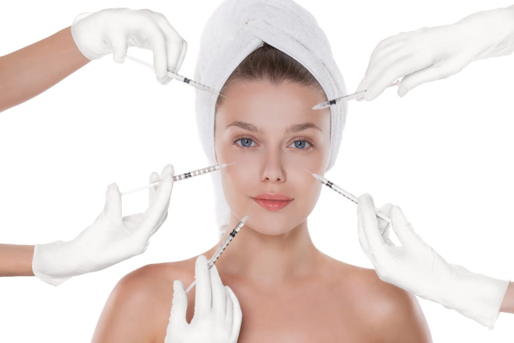 Injectable Filler Facts. Young woman getting cosmetic injections in her face.
